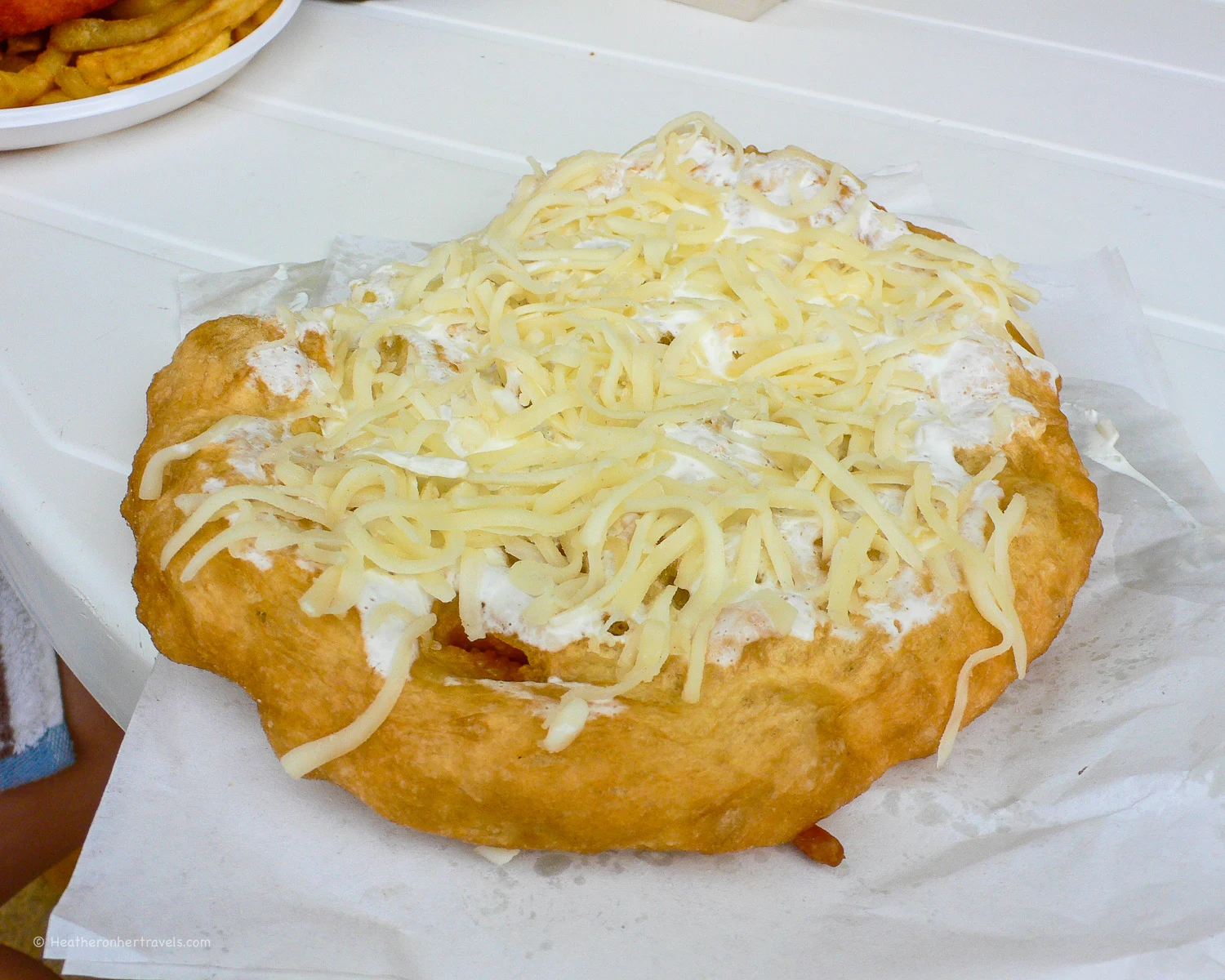 Lángos with sour cream and cheese in Hungary